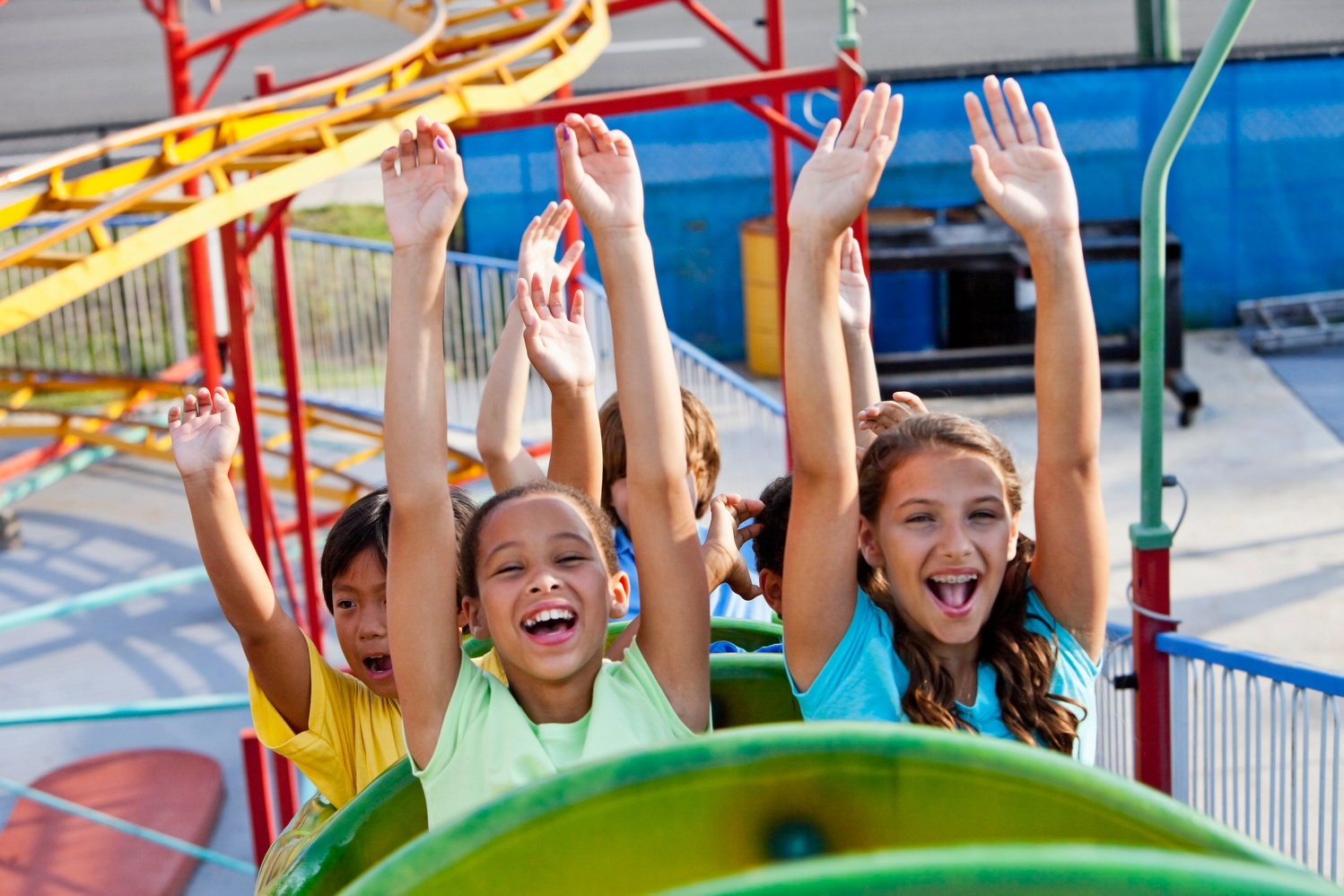 Children riding a roller coaster